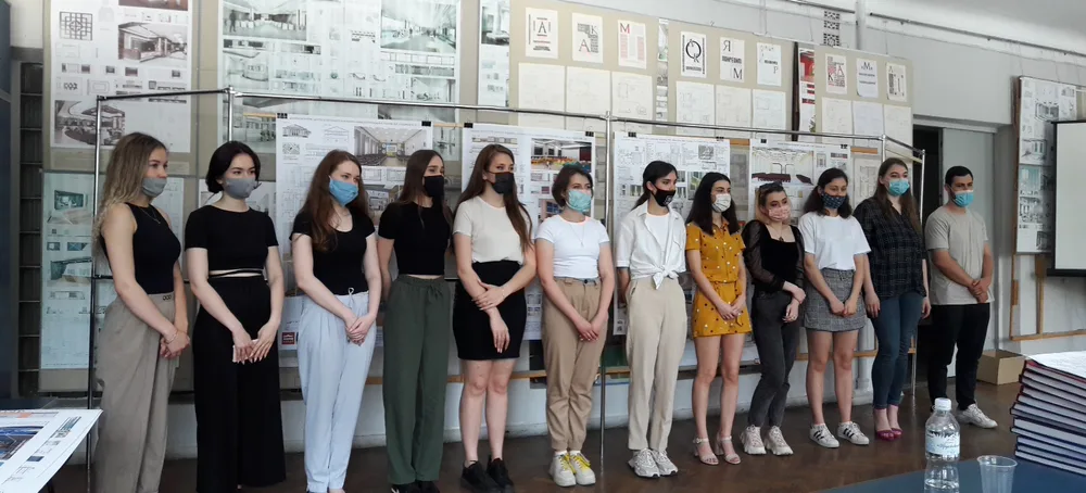 Students and teachers with architectural presentation boards
