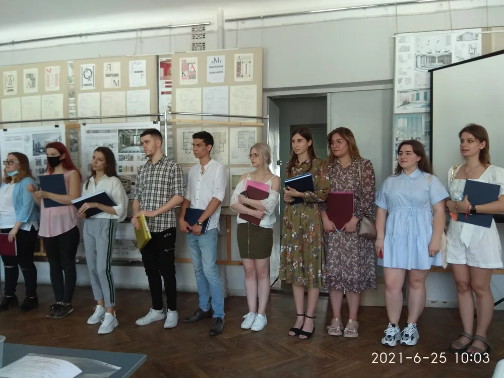 Students with drawings and models in a classroom