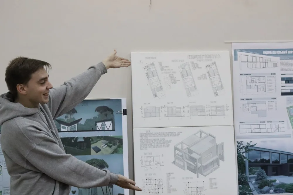 A student presenting architectural drawings